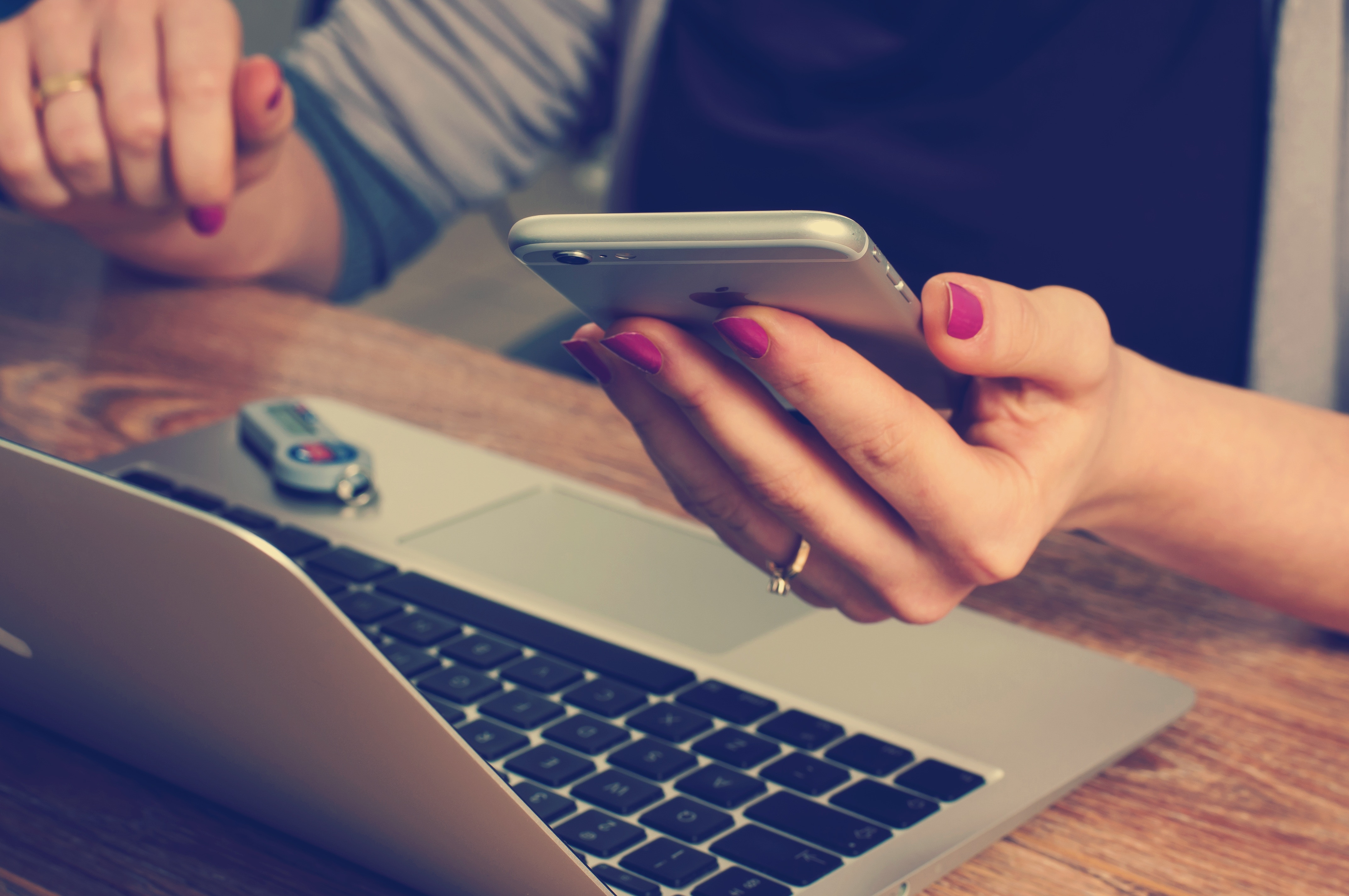 Lady at a PC holding a phone